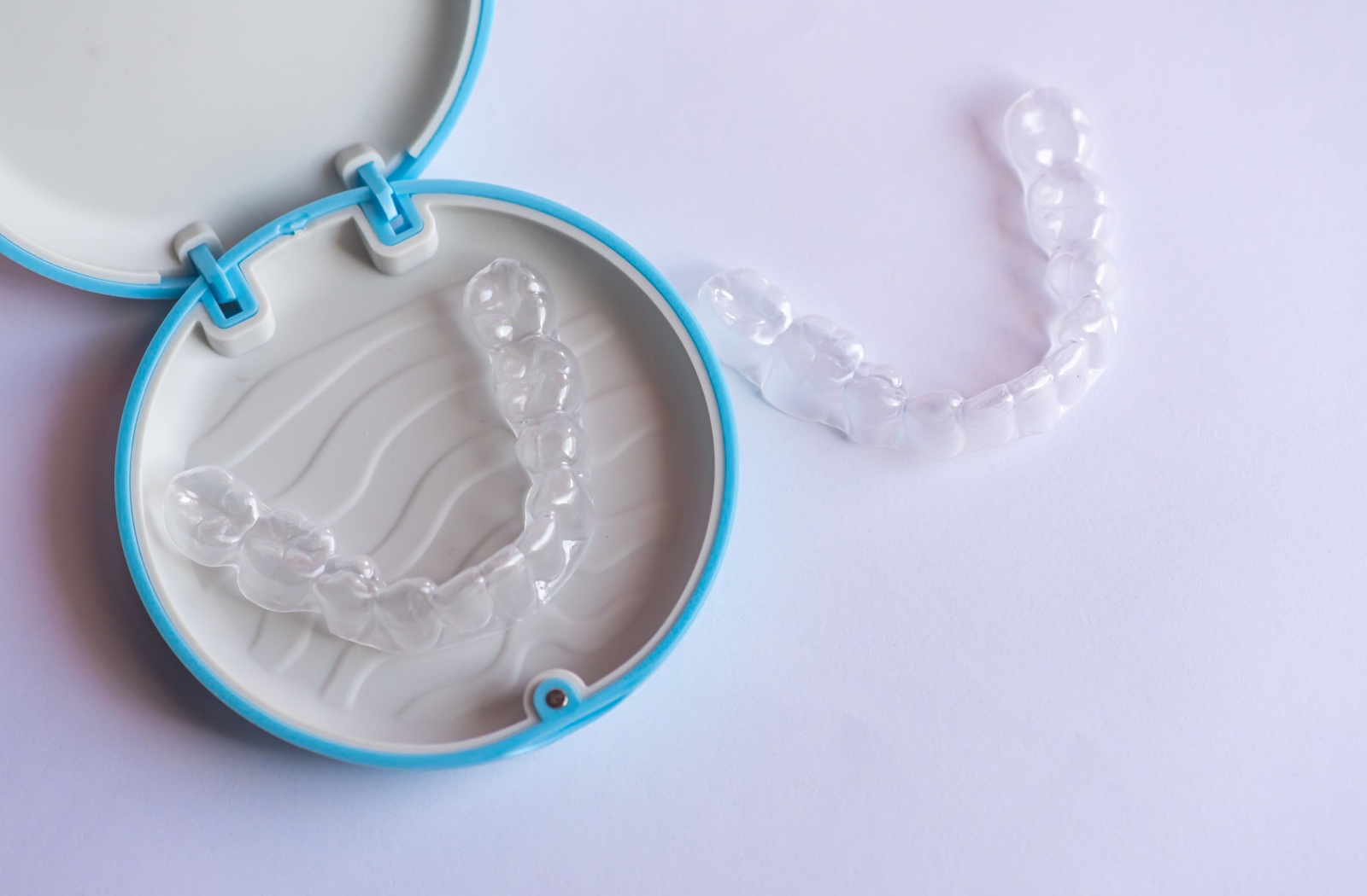 Clean Invisalign case open with clear aligners neatly placed inside.