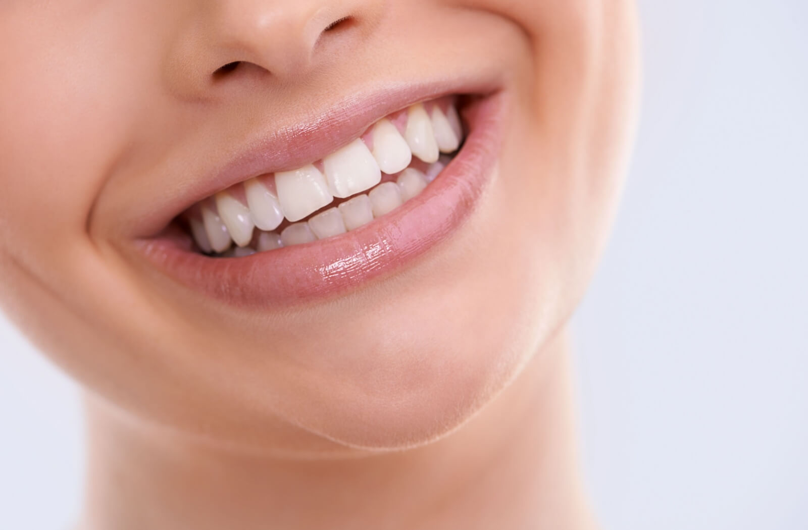 A close-up picture of a person with their beautiful new smile.