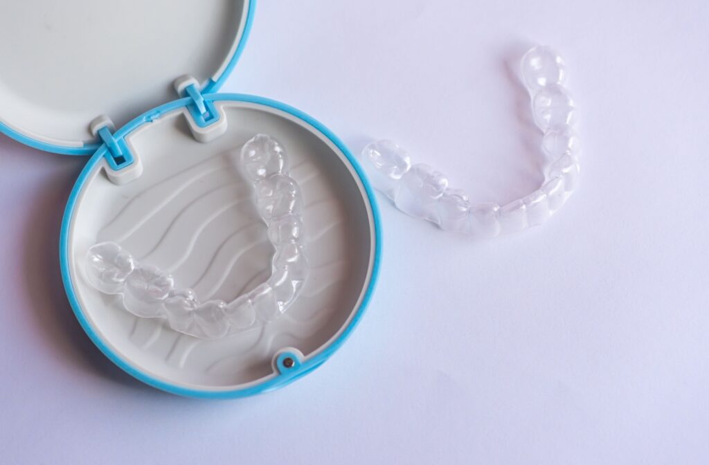 Clean Invisalign case open with clear aligners neatly placed inside.