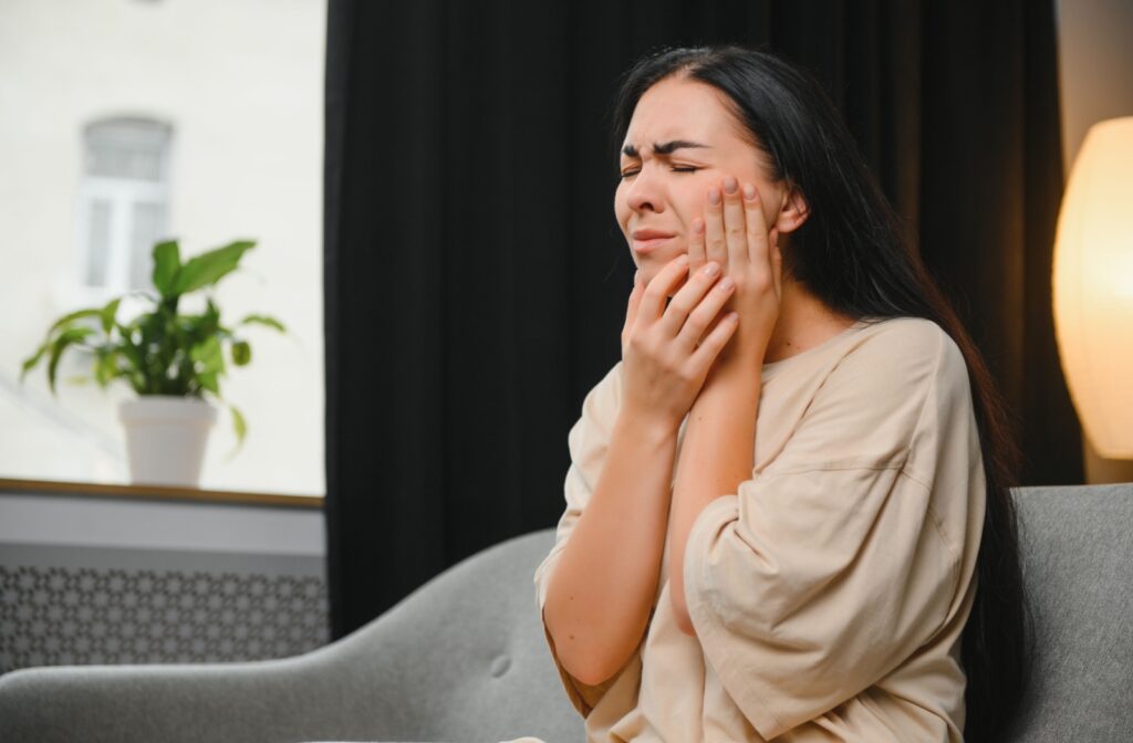 A person at home experiencing discomfort from periodontitis.